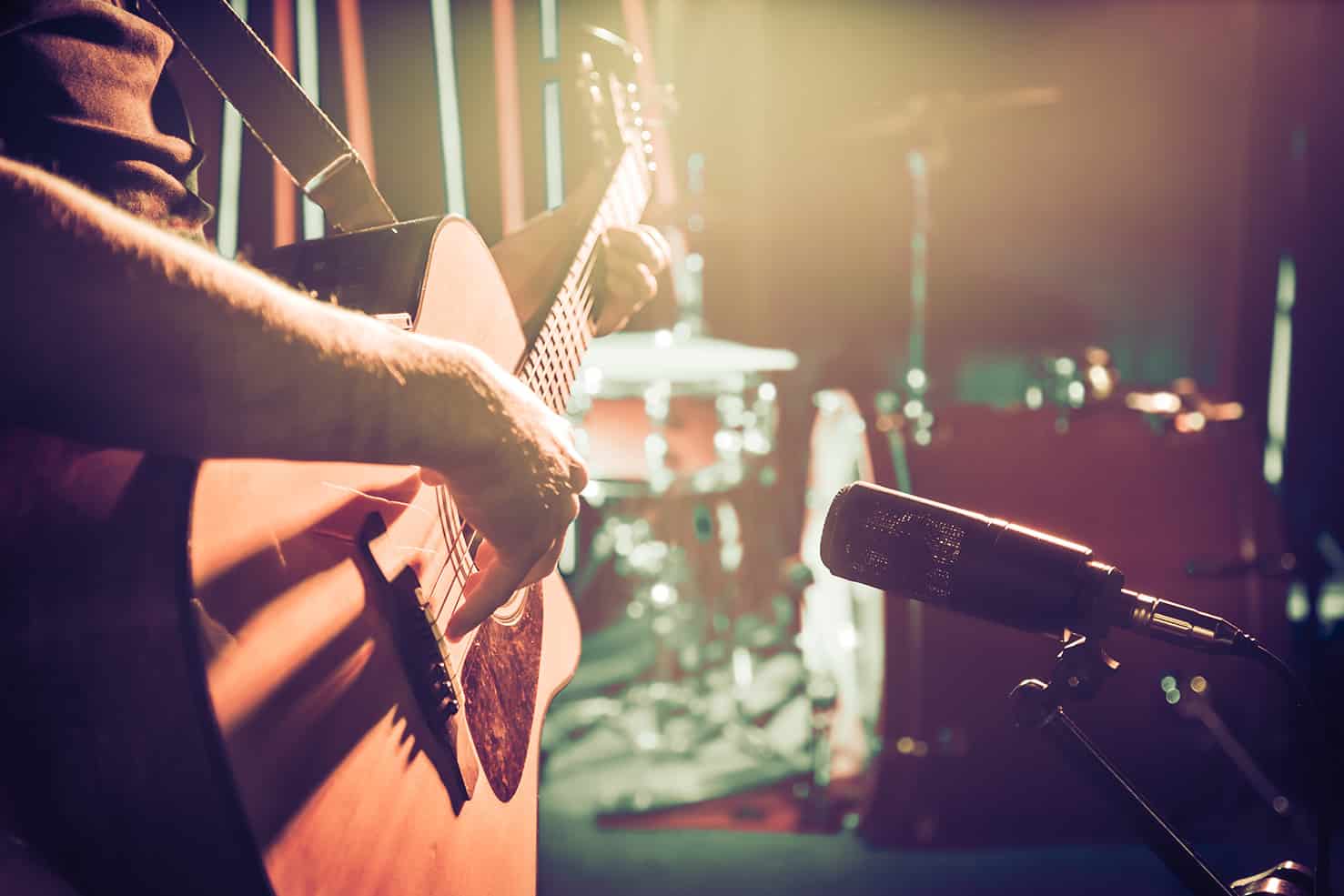 person playing guitar and microphone